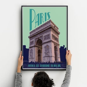 May include: A framed poster with a vintage design featuring the Eiffel Tower in Paris, France. The poster has a teal green background with a navy blue border and the text "Paris" in a teal green font. The text "Office de Tourisme Francais" is at the bottom of the poster.