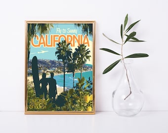 May include: A vintage-style travel poster with a gold frame, featuring a silhouette of two people standing on a beach in front of palm trees and the ocean. The poster reads "Fly to Sunny CALIFORNIA" and "CALIFORNIA DEPARTMENT OF TOURISM".