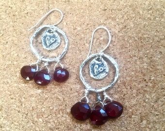 rings of fire! 3 dark red garnet gemstones hang from oxidized silver hoops with love/heart charms in center French wires boho drop earrings