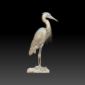 May include: A detailed, 3D-printed sculpture of a heron standing on a rock. The heron is depicted in a light gray color with intricate details on its feathers and legs.