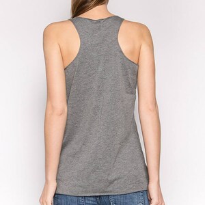 May include: A heather gray sleeveless tank top with a scoop neck. The tank top is made of a soft, comfortable fabric.