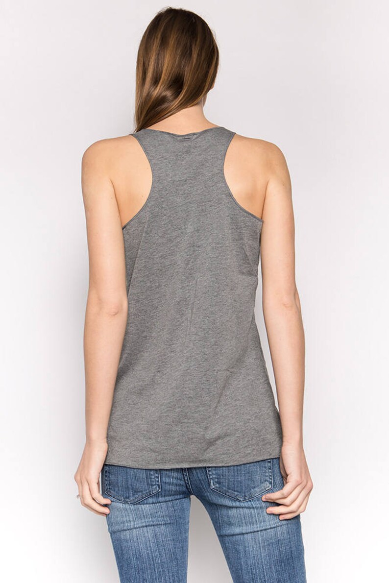 May include: A heather gray sleeveless tank top with a scoop neck. The tank top is made of a soft, comfortable fabric.