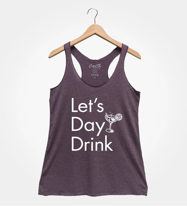 May include: A purple racerback tank top with the text "Let's Day Drink" and a white silhouette of a margarita glass with a lime wedge.