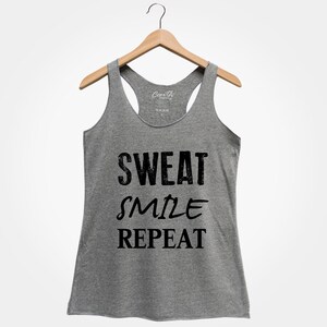 May include: Gray tank top with the text "SWEAT SMILE REPEAT" printed in black.