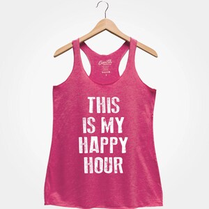 Puede incluir: Camiseta de tirantes rosa con el texto "This is my happy hour" en blanco.