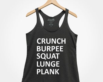 May include: A dark grey tank top with the words "CRUNCH BURPEE SQUAT LUNGE PLANK" printed in white.