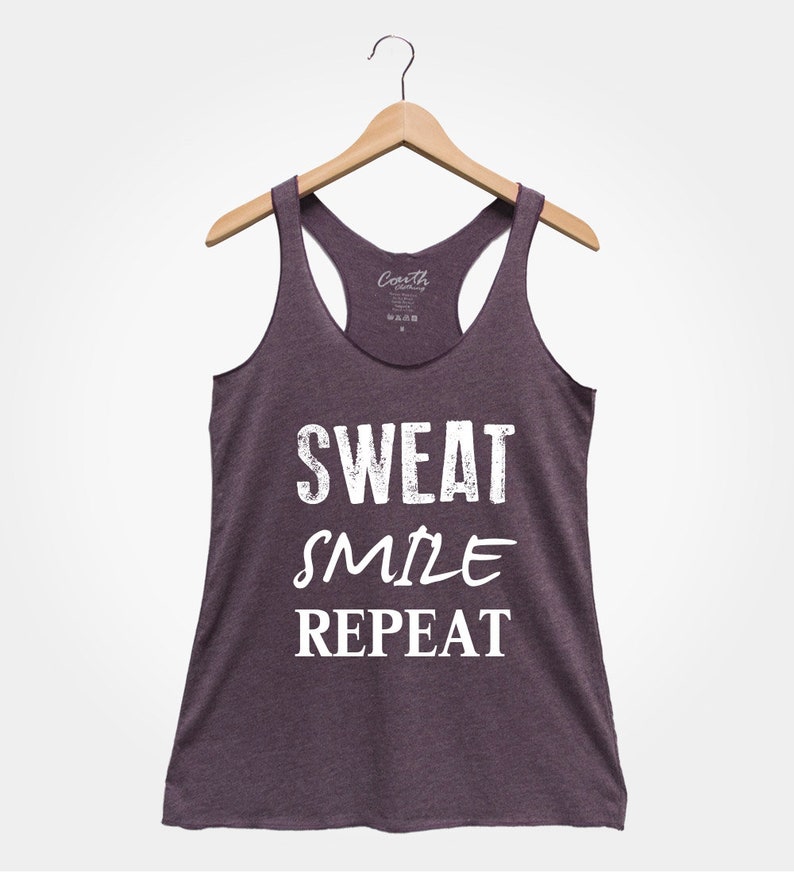 May include: A purple tank top with the text "SWEAT SMILE REPEAT" in white.
