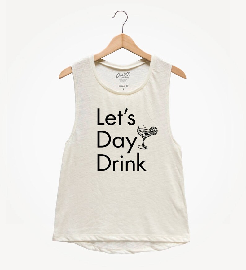 May include: A white sleeveless tank top with the text "Let's Day Drink" and a black and white illustration of a cocktail glass with a lemon wedge.