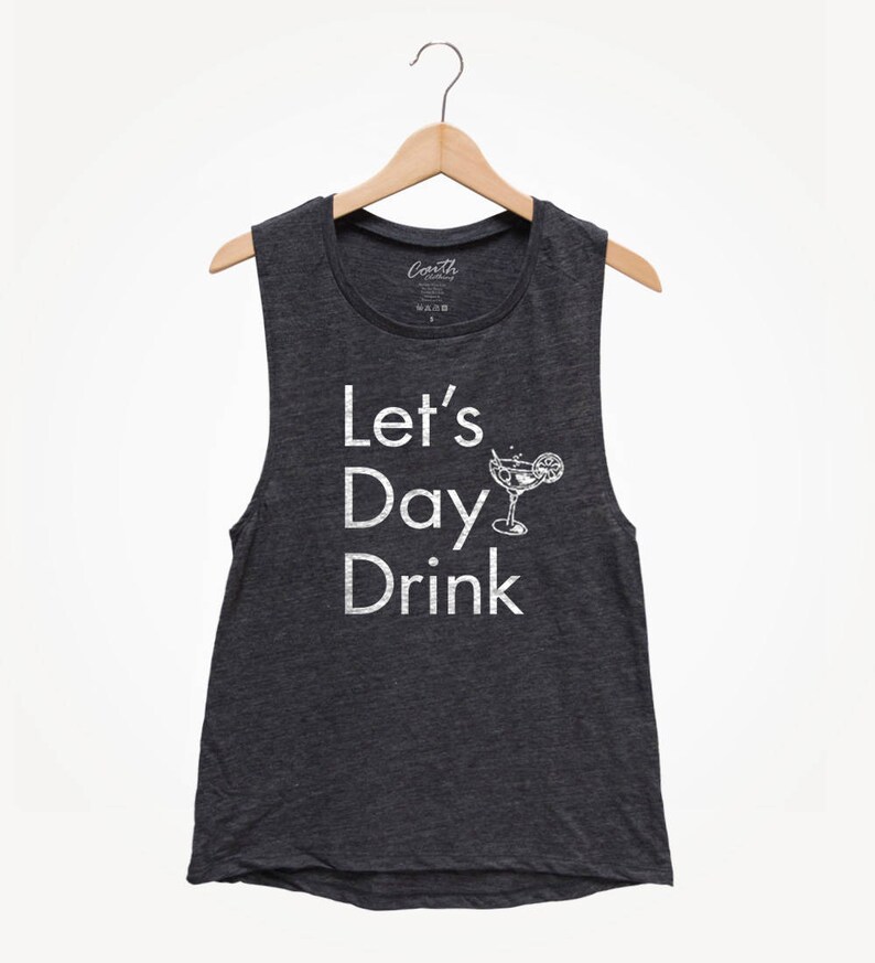 May include: A dark gray sleeveless shirt with the text "Let's Day Drink" in white lettering. A white outline of a cocktail glass with a lime wedge is next to the text.