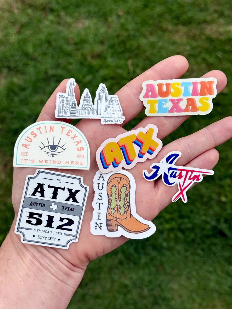 May include: A collection of colorful stickers featuring designs related to Austin, Texas. Designs include the city skyline, the text "Austin Texas" in various fonts, a cowboy boot, and the area code 512.