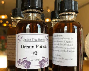May include: A small, clear glass bottle with a black dropper top and a white label that reads "Linden Tree Herbals Dream Potion #3 1 oz/30ml". The bottle is filled with a dark brown liquid. The label has a purple floral design.
