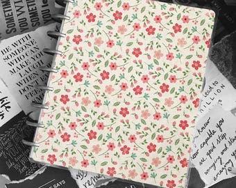 May include: A white and pink floral patterned notebook cover with a black and white quote that reads "Every child is gifted. They just unwrap their packages at different times."