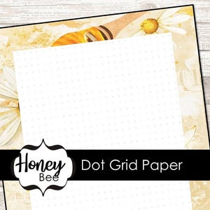 May include: Dot grid paper with a floral design. The paper has a white dotted grid pattern, surrounded by a cream-colored border with daisy and bee illustrations. The Honey Bee logo is at the bottom.