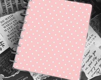 May include: A pink polka dot notebook with a clear plastic cover. The notebook has a ring binder and is surrounded by inspirational quotes.