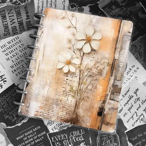 May include: A close-up of a brown leather bound journal with white flowers pressed inside. The journal has a ring binding system and is decorated with torn pieces of paper with inspirational quotes. The quotes include "Every child is gifted" and "Be full of joy".