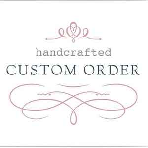 May include: A white background with a decorative border and text that reads "handcrafted CUSTOM ORDER" in a mix of grey and navy blue fonts. The design includes a decorative flourish and a heart-shaped emblem.