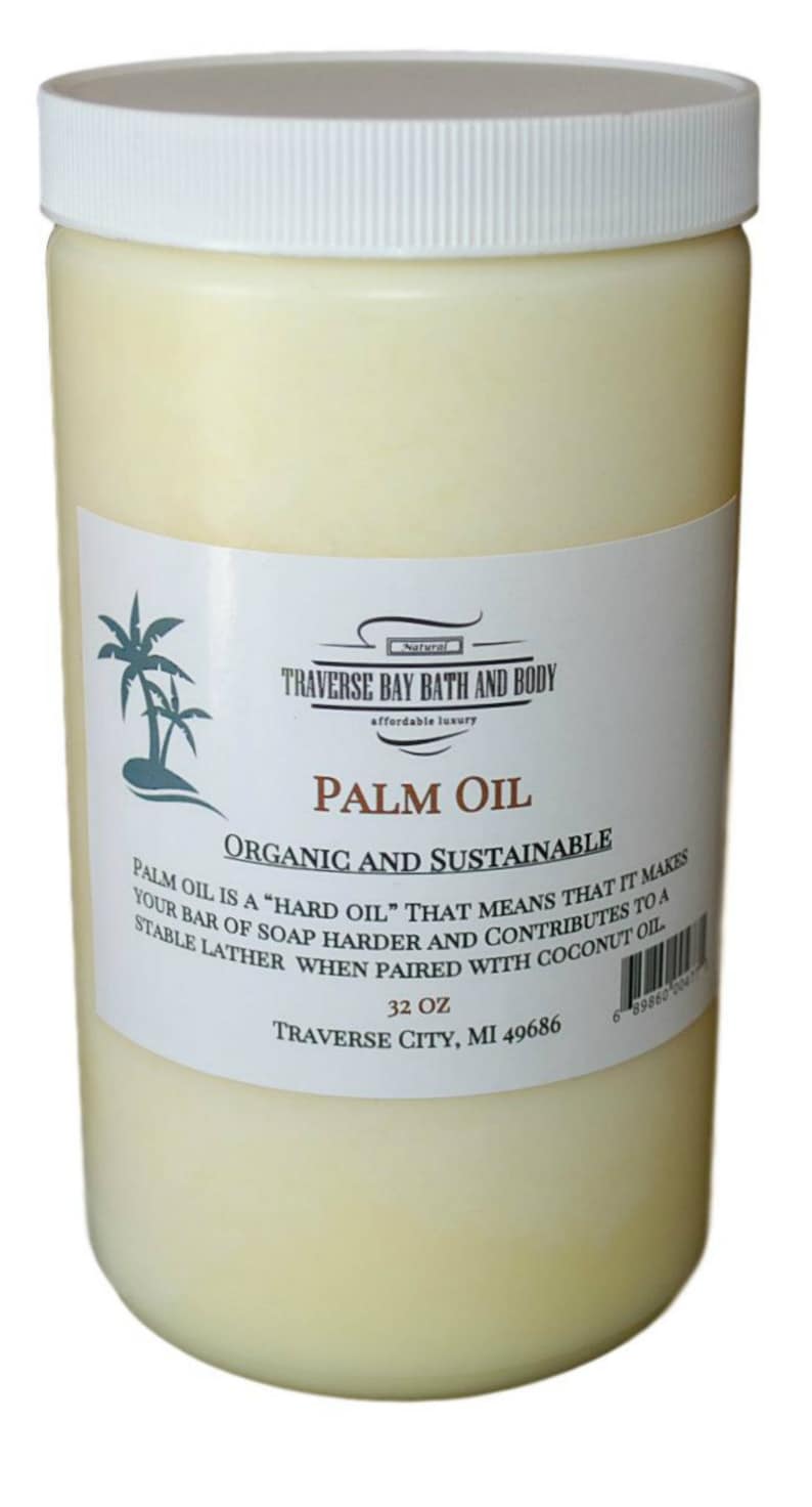 May include: A clear plastic jar filled with a white, solid substance labeled "Palm Oil" with the text "Organic and Sustainable". The label also includes the brand name "Traverse Bay Bath and Body" and the text "32 oz Traverse City, MI 49686".