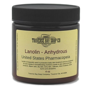 May include: A brown jar of Lanolin - Anhydrous from Traverse Bay Soap Co. The label includes the text "United States Pharmacopeia" and "4 oz". The jar has a black lid and a yellow label with product information.