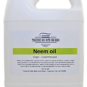 May include: A white plastic bottle of 32 ounce Neem oil, labeled "Natural Traverse Bay Bath and Body, affordable luxury, Neem oil, Virgin - Cold Pressed". The label describes the benefits of Neem oil for skin and hair.