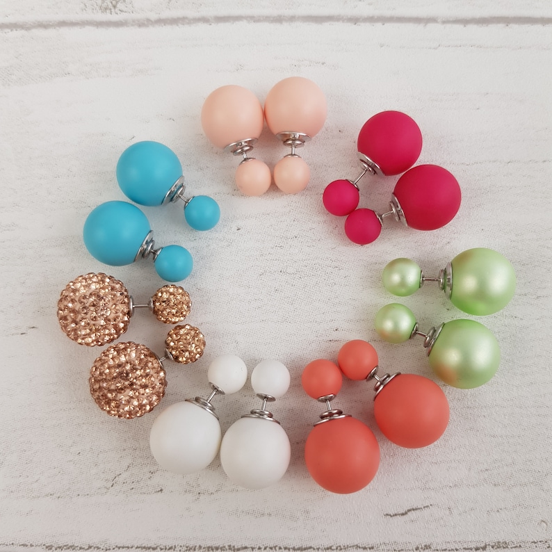 May include: A set of 12 pairs of double-sided earrings. The earrings are made of various materials, including glitter, pearl, and matte finish. The earrings are in a variety of colors, including pink, blue, green, and white.