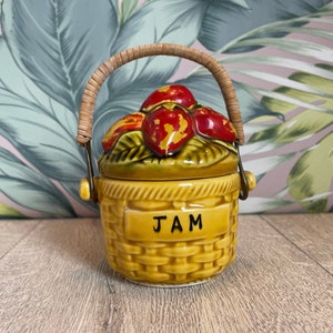 Strawberry jam  pot - vintage storage pot for preserves - decorative  basket jar with fruit lid and wicker handle - has a hairline crack