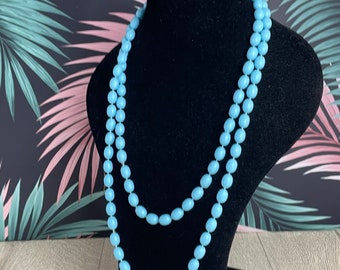 Long strand of oval baby blue plastic beads in an opera length - vintage flapper style necklace for women