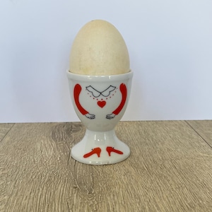 Vintage ceramic egg cup with red shoes