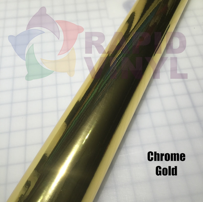 May include: A roll of chrome gold vinyl wrap. The vinyl has a shiny, reflective surface.