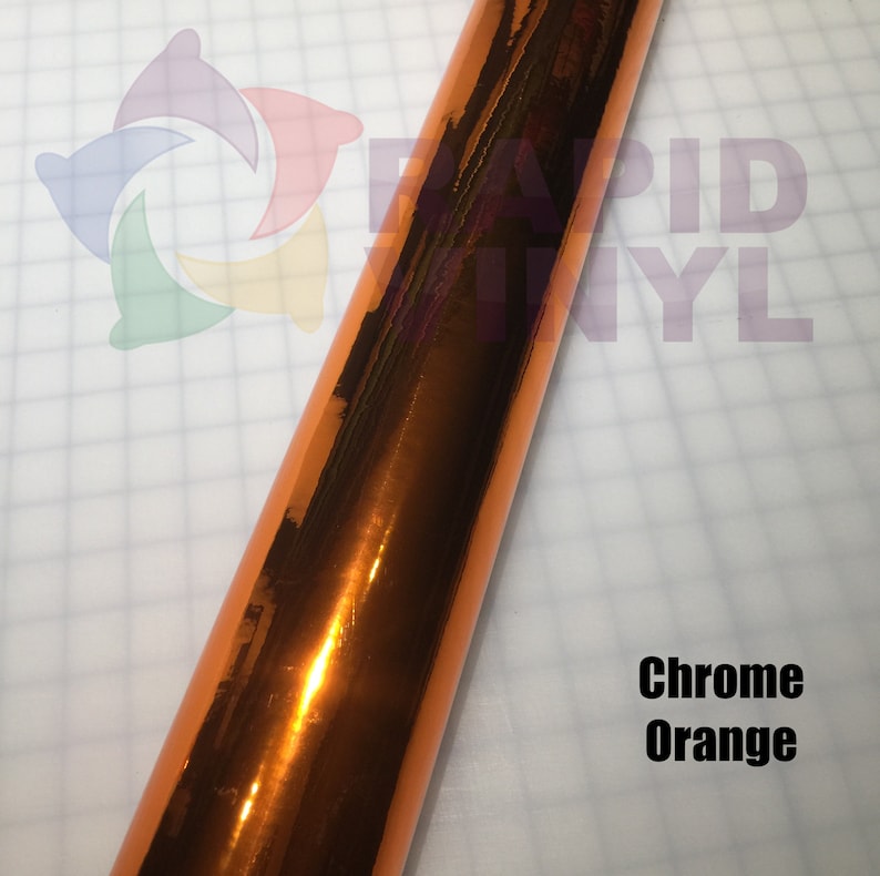May include: A roll of chrome orange vinyl wrap. The vinyl has a reflective finish.