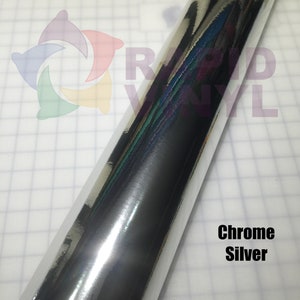 May include: A roll of chrome silver vinyl with a reflective surface. The vinyl is on a white background with a grid pattern.