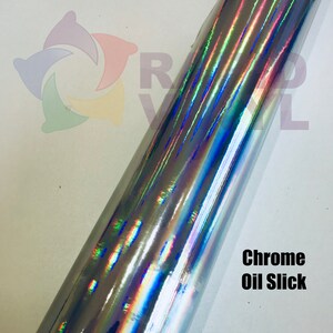 May include: A roll of chrome oil slick vinyl with a holographic iridescent finish. The vinyl has a metallic sheen with blue, green, and purple hues.