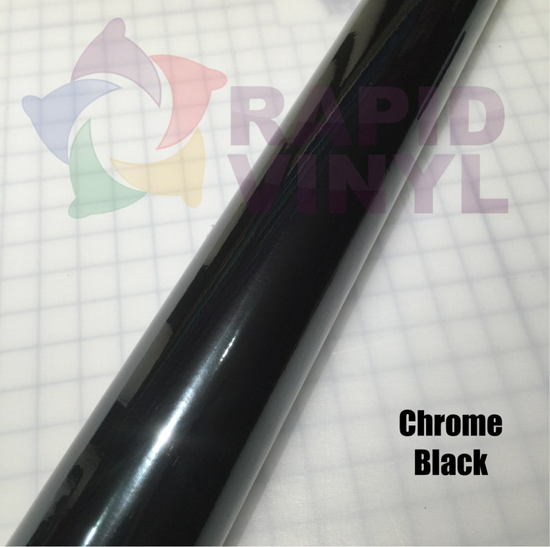 May include: A roll of chrome black vinyl wrap. The vinyl is shiny and reflective. The text "RAPID VINYL" is visible on the roll.