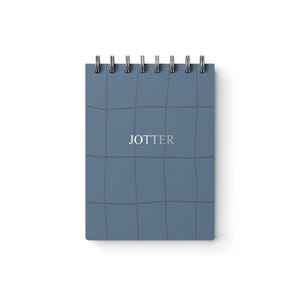May include: A small, spiral-bound notepad with a blue grid pattern. The word "JOTTER" is printed in the center of the cover. The notepad is rectangular and has a silver spiral binding at the top.