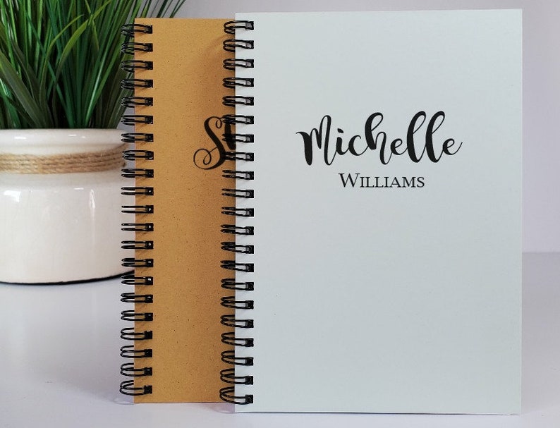 Personalized handmade notebooks with the names centered on the cover. The custom handmade notebooks are available in the colors kraft, white, rose (dusky pink), honeycomb (yellow), powder green and light blue.