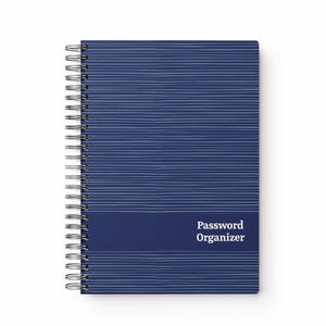 May include: A navy blue spiral-bound notebook with a pattern of light blue horizontal lines. The bottom section is a darker blue with the words "Password Organizer" in white. It has a silver spiral binding.