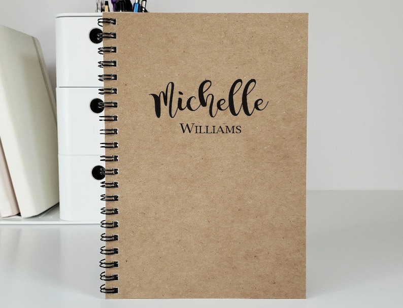 Personalized notebook with the name centered on the cover. The notebook shown is with kraft covers. These custom notebooks are great for girls or boys, and women. Perfect gift idea for party favors, students and teachers.