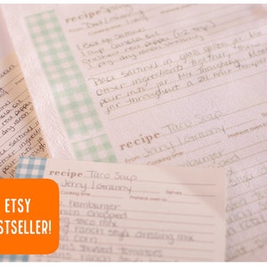 May include: A set of three recipe cards with a blue and white checkered pattern. The cards are made of white fabric and have handwritten recipes for "Taco Soup" and "Spicy Crackers". The cards are labeled "Etsy Bestseller!" in orange.