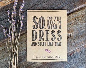 May include: A brown card with the text "SO. YOU WILL HAVE TO WEAR A DRESS AND STUFF LIKE THAT. I guess I'm wondering..." printed in black. Two small pink hearts are printed above the last line of text.