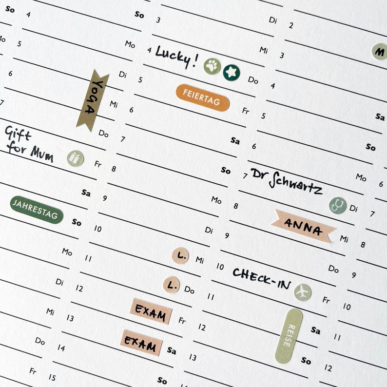 May include: A close-up of a white planner page with handwritten notes and decorative stickers. The planner includes entries like "Lucky!", "Yoga", "Gift for Mum", "Exam", and "Check-in". Stickers include paw prints, stars, and medical symbols.