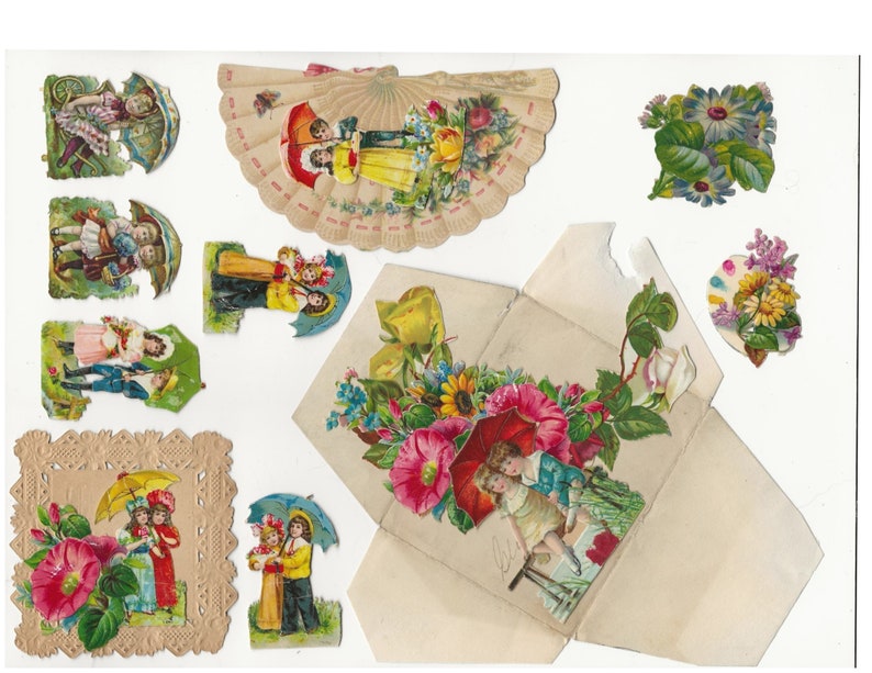 Op de afbeelding: Een vintage papieren knutselset met kinderen met paraplu's en bloemmotieven. De set bevat een waaierkaart, een doos met een bloemmotief en verschillende individuele uitsnijdingen.