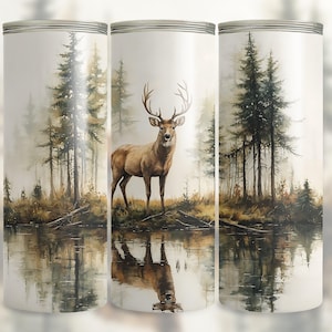 May include: A watercolour painting of a deer standing in a woodland with a lake in the foreground. The deer is brown with large antlers and is looking to the right. The woodland is made up of tall, green trees. The lake is calm and reflects the trees and deer.