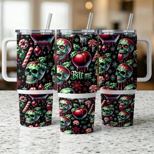 May include: Three stainless steel travel mugs with white handles and straws. The mugs feature a black background with a repeating pattern of green skulls, red apples, holly, and candy canes. The text "Bite Me" is also visible.