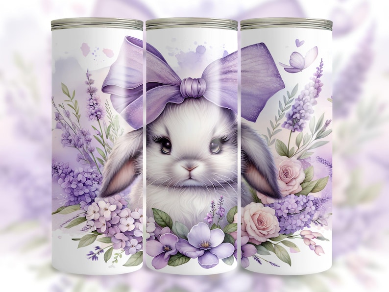 A beautiful 20 oz tumbler wrap featuring an adorable white Easter bunny with big, expressive eyes, wearing a large purple bow. Surrounded by soft pastel florals, lavender, and butterflies in a dreamy watercolor style on a white background