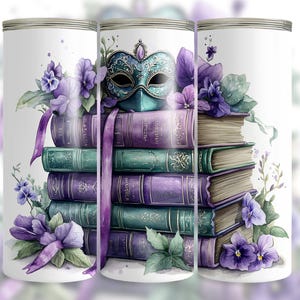 May include: Three white tumblers with a stack of books, a purple and green masquerade mask, and purple flowers. The books have gold lettering and are tied together with a purple ribbon.