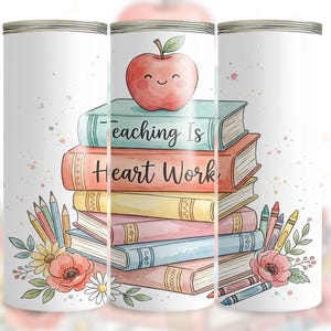 May include: White tumbler featuring a stack of books with the text "Teaching Is Heart Work." A smiling red apple sits atop the books. The design includes pencils, crayons, and floral accents, perfect for teachers.