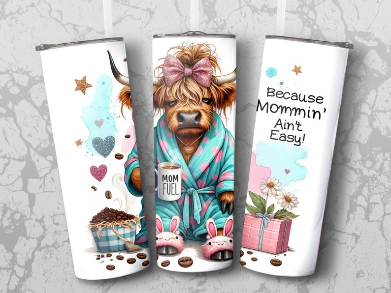 A funny Highland cow in a polka-dot robe, pink bunny slippers, and coquette bow holding a "Mom Fuel" mug, surrounded by coffee beans, glitter hearts, daisies, and a pink gift box. Text reads, "Because Mommin’ Ain’t Easy!" on a playful background.