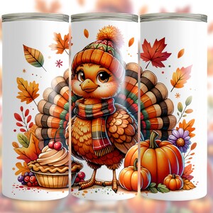 May include: A white tumbler featuring a cartoon turkey wearing a hat and scarf, surrounded by fall leaves, pumpkins, and a pie. The design is in warm autumn colors, perfect for Thanksgiving.