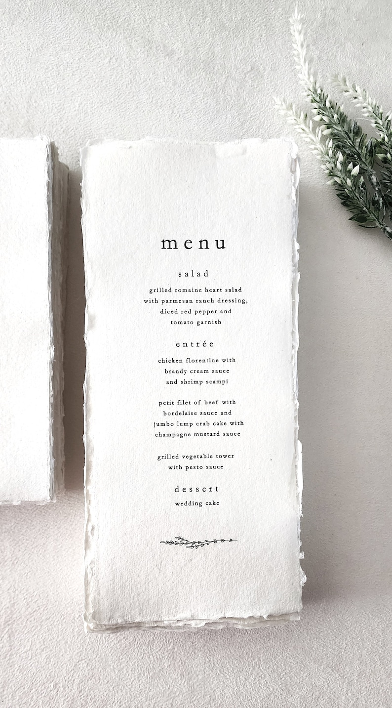 Custom wedding menu printed on handmade cotton rag deckle edge paper with minimalist black typography, shown in a 4x9 format.