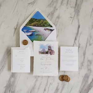Destination wedding invitation suite with handmade deckle edge invitation, watercolor venue artwork, scenic envelope liner, RSVP and details cards, and gold wax seals.