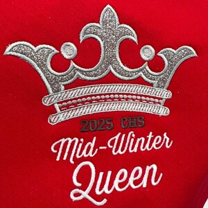 May include: A red embroidered patch with a silver glitter crown, the text "2025 CHS" and the words "Mid-Winter Queen" in a cursive font.